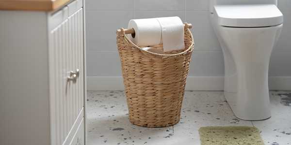 A laundry basket in a bathroom.